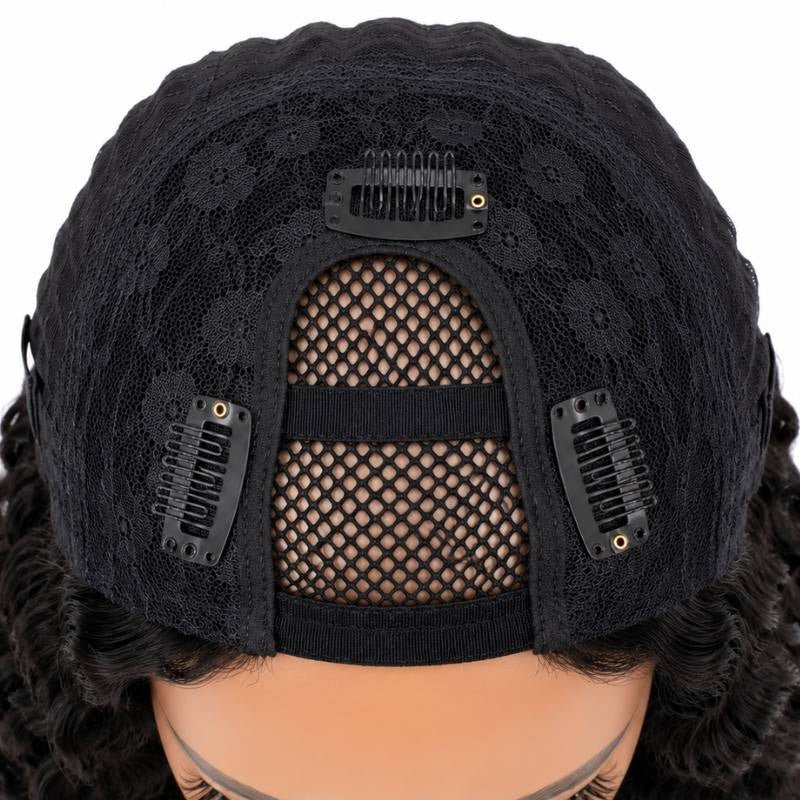 Cap of a natural black deep wave human hair wig seen from above with the U shaped mesh opening and three snap clips stitched around it