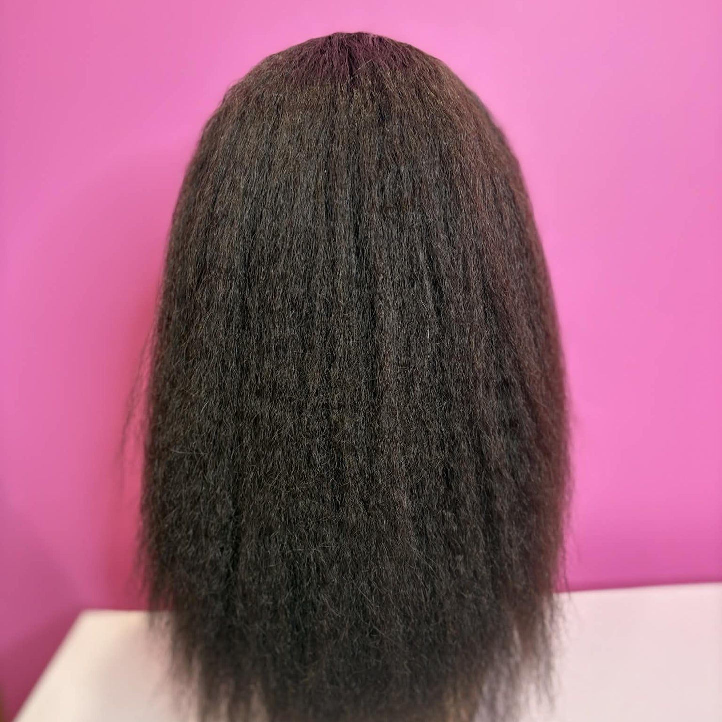 Back view of 12 inch kinky straight u-part human hair wig on mannequin showing blow-out texture and natural volume