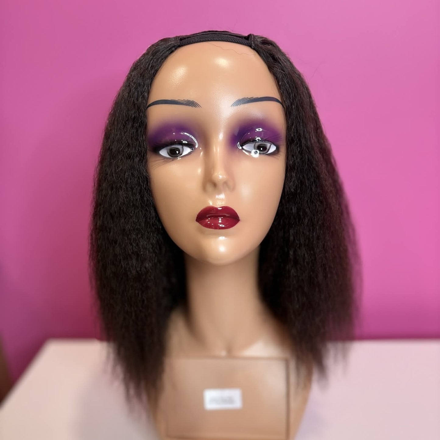 Front view of 12 inch kinky straight u-part human hair wig on mannequin showing u-part opening and natural styling