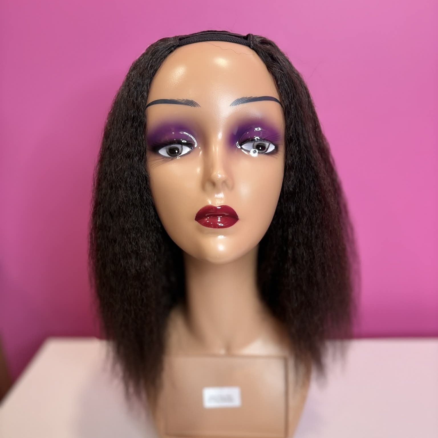 Front view of 12 inch kinky straight u-part human hair wig on mannequin showing u-part opening and natural styling