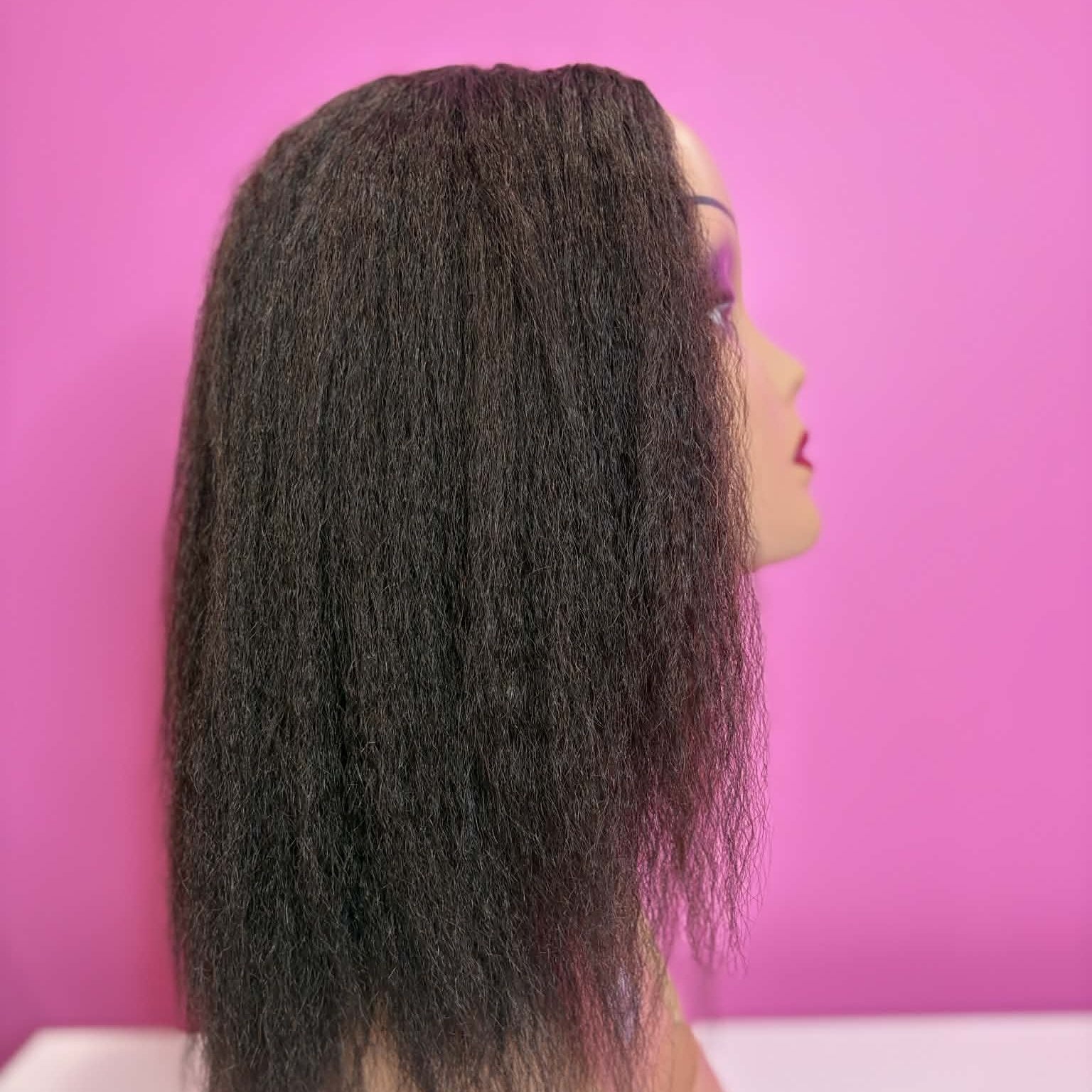 Left side profile of 12 inch kinky straight u-part human hair wig on mannequin showing yaki texture and length