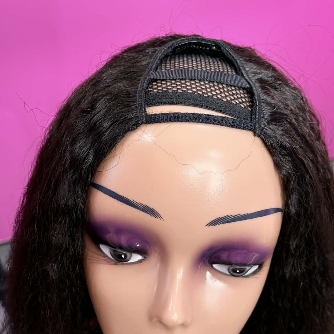 Front view of mannequin wearing 12 inch kinky straight u-part human hair wig with business card showing u-part and texture
