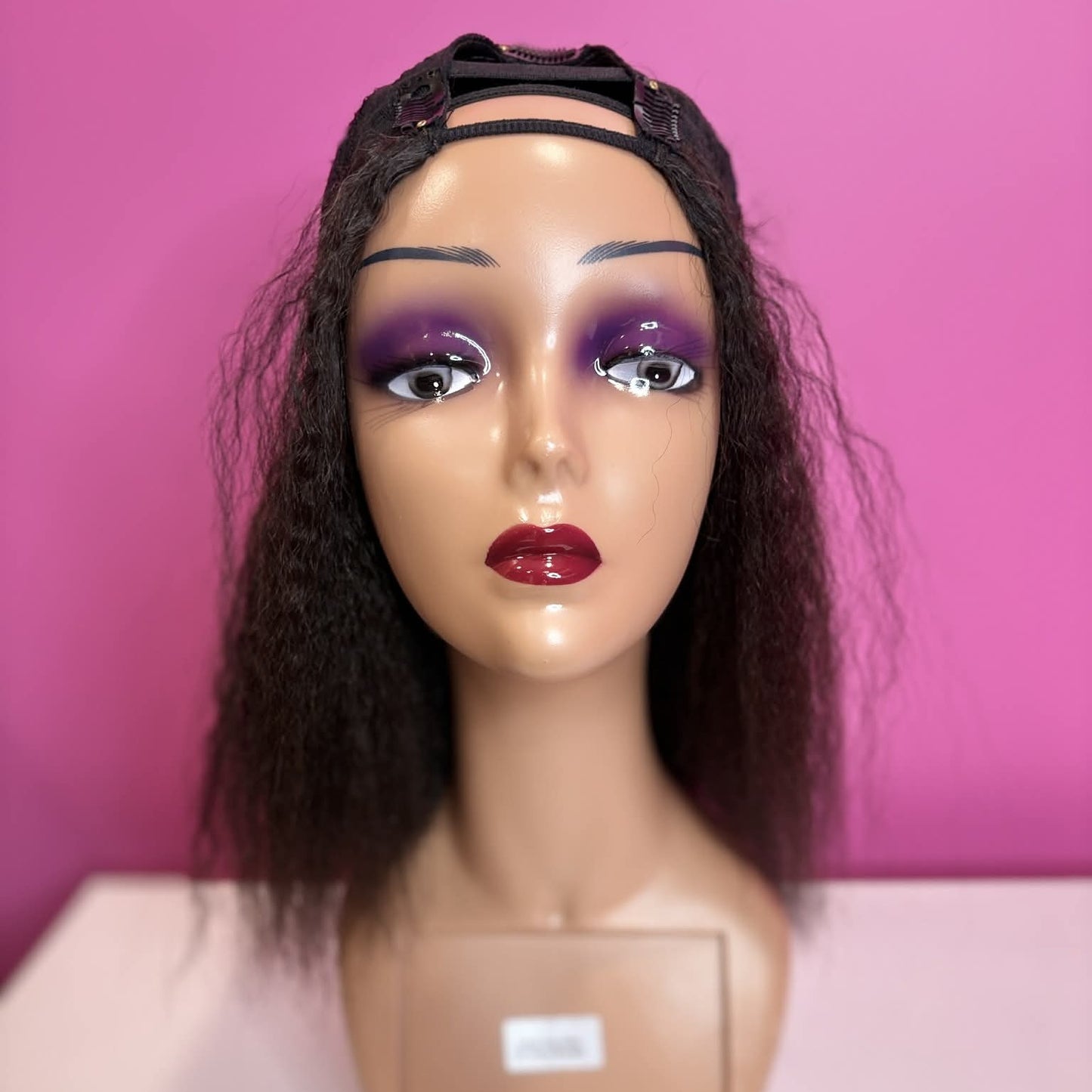 Front view of model wearing 12 inch kinky straight u-part human hair wig blended with natural hair showing seamless integration
