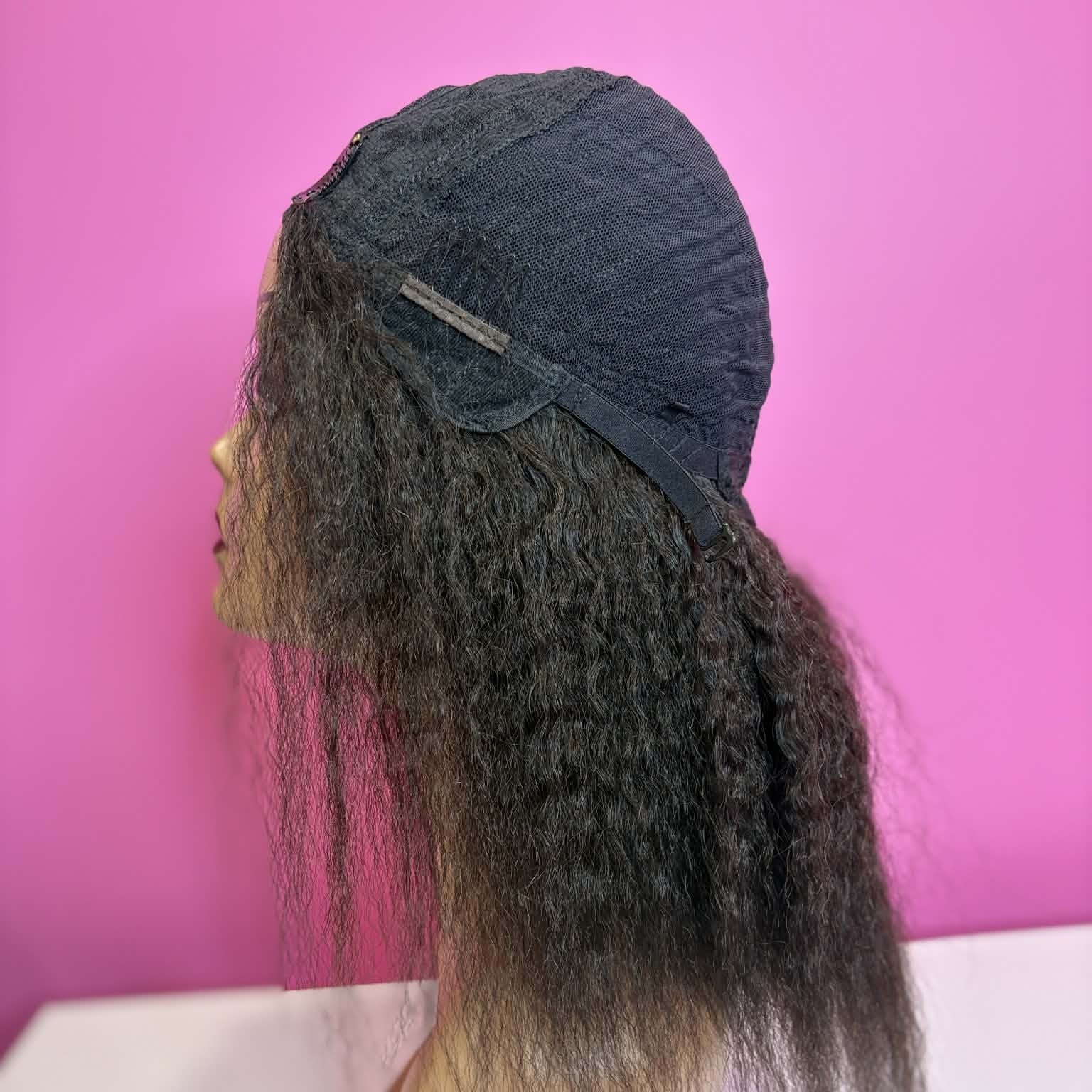 Left side of model wearing 12 inch kinky straight u-part human hair wig showing natural hair blend and yaki texture
