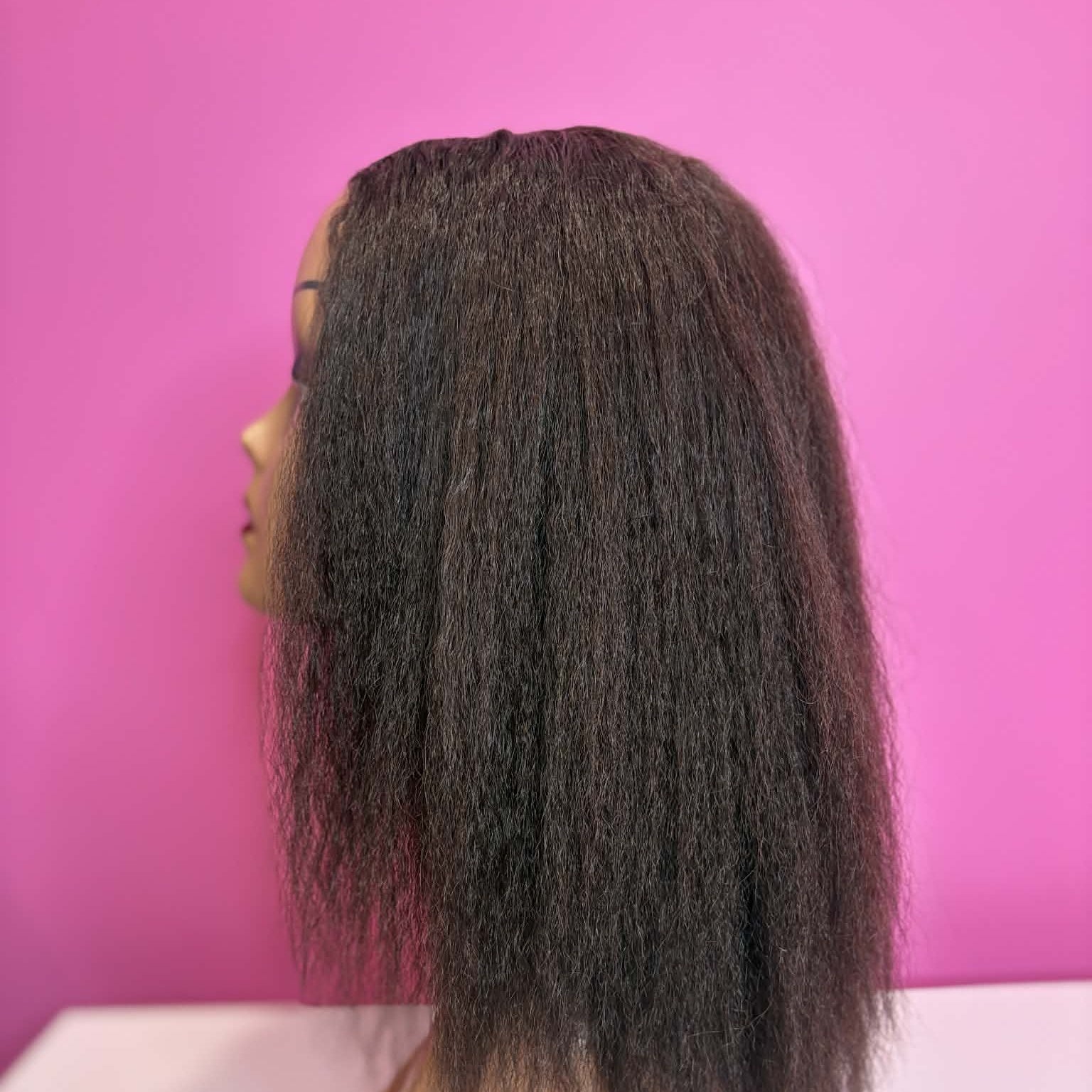 Right side profile of 12 inch kinky straight u-part human hair wig on mannequin showing blow-out texture and volume