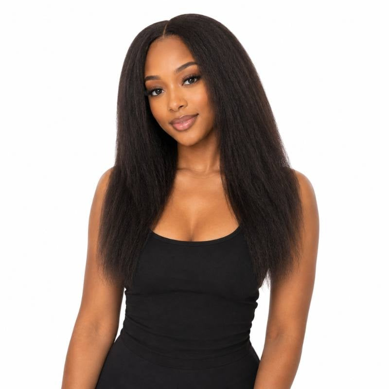 Model wearing a natural black kinky straight human hair wig with a middle part and blown out texture falling past the chest
