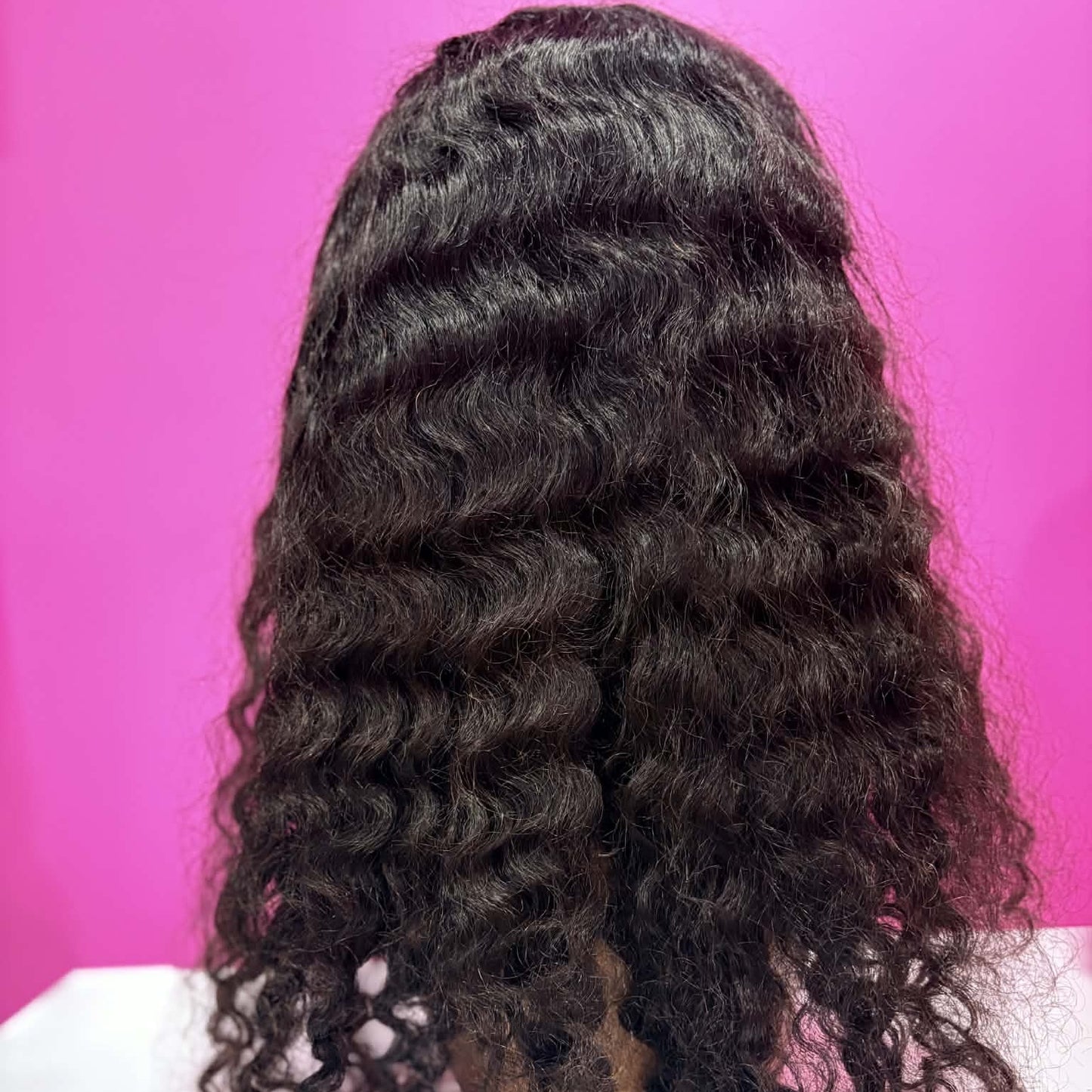 Back view of 22 inch deep wave 13x4 HD lace front human hair wig in natural black showing full wave pattern and length on mannequin head