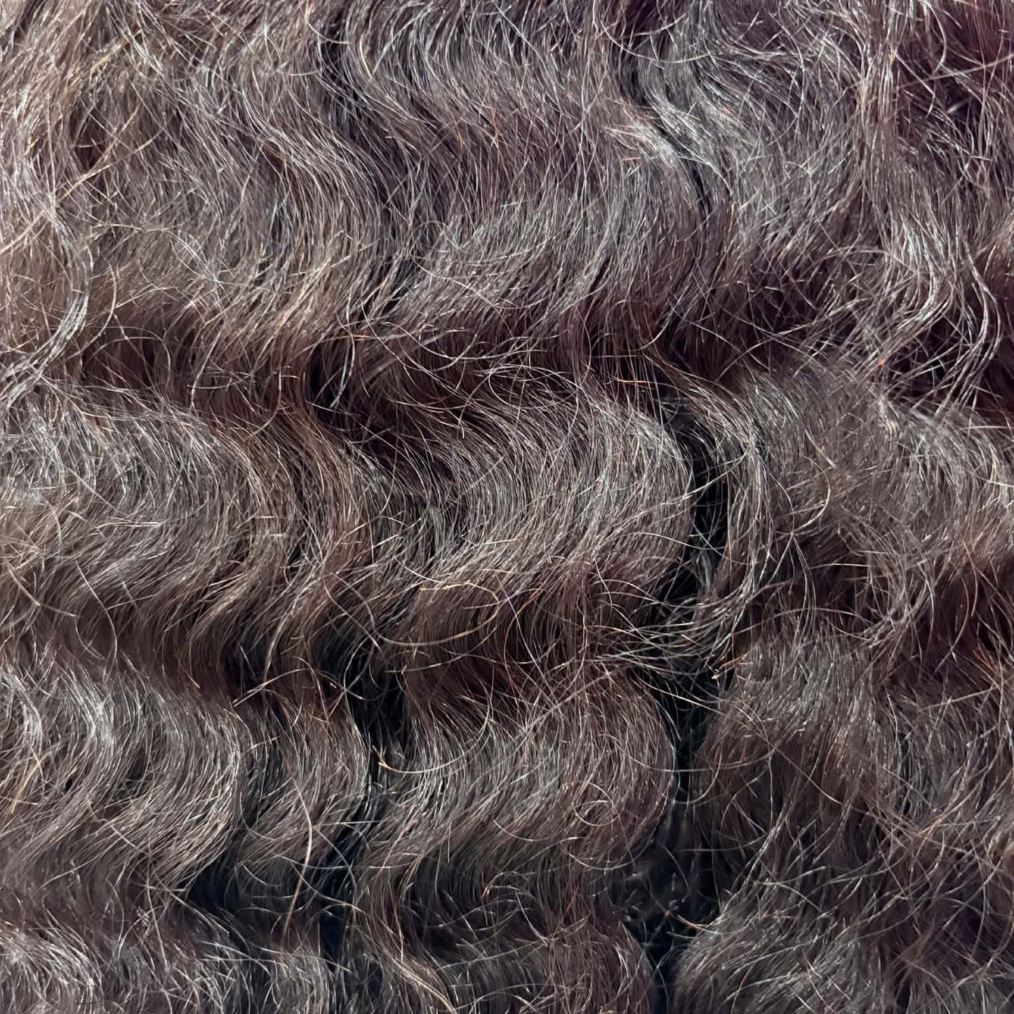 Macro close-up of deep wave curl pattern on 22 inch 13x4 HD lace front human hair wig showing hair texture and natural shine