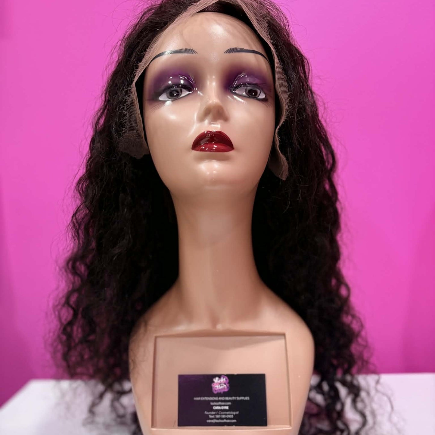 Front view of 22 inch deep wave 13x4 HD lace front human hair wig in natural black on mannequin head showing lace frontal hairline and full styling