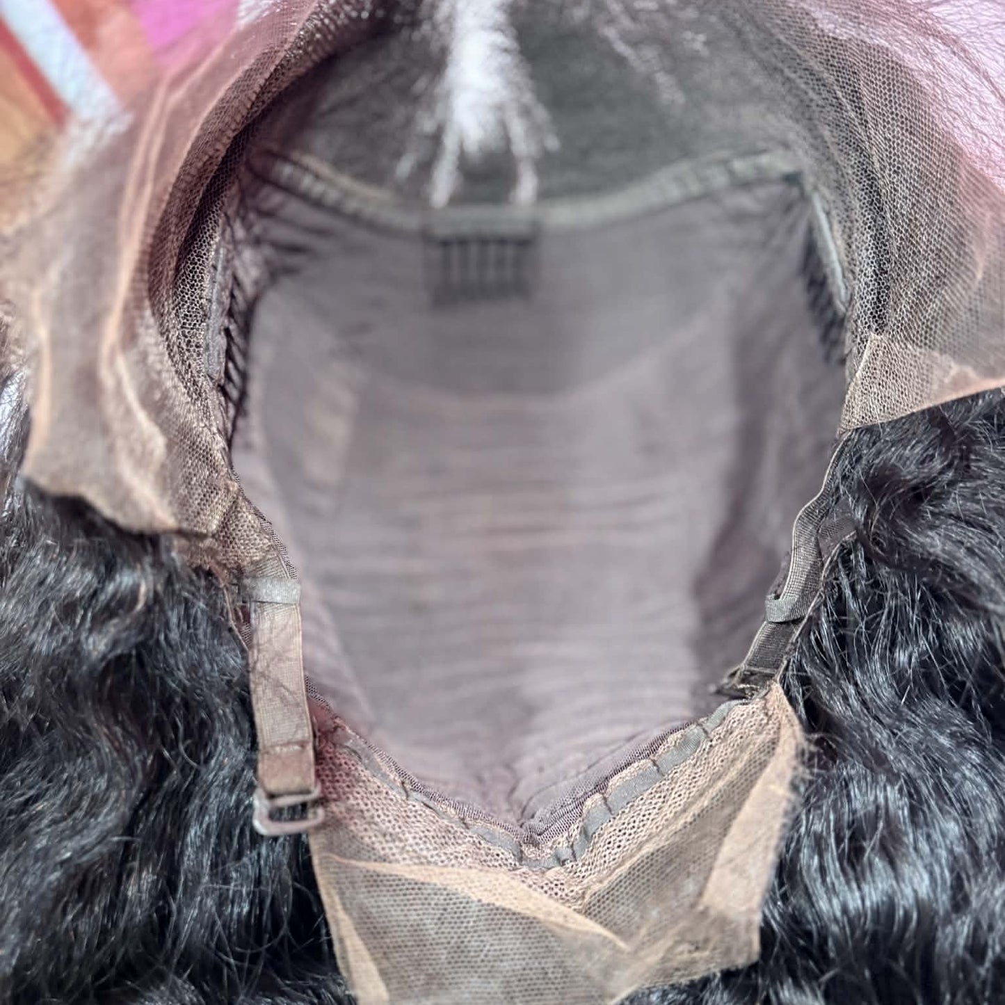 Interior cap construction of 22 inch deep wave 13x4 HD lace front human hair wig showing lace frontal area and wig cap structure