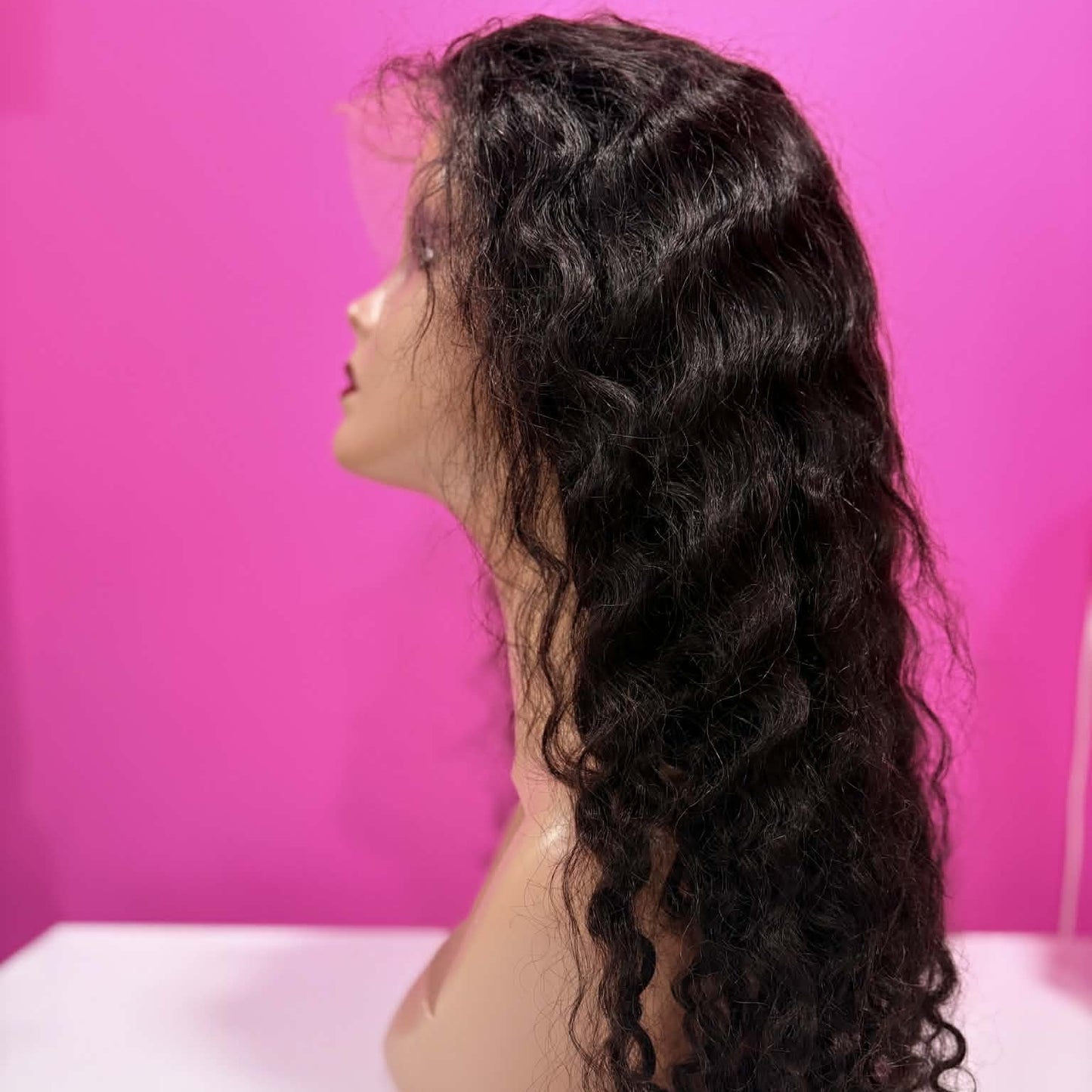 Left side profile of 22 inch deep wave 13x4 HD lace front human hair wig in natural black on mannequin showing wave pattern and natural movement