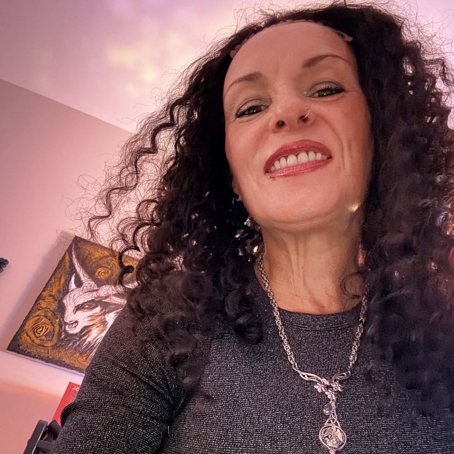 Selfie from below wearing 22 inch deep wave lace front human hair wig showing voluminous curls and necklace detail