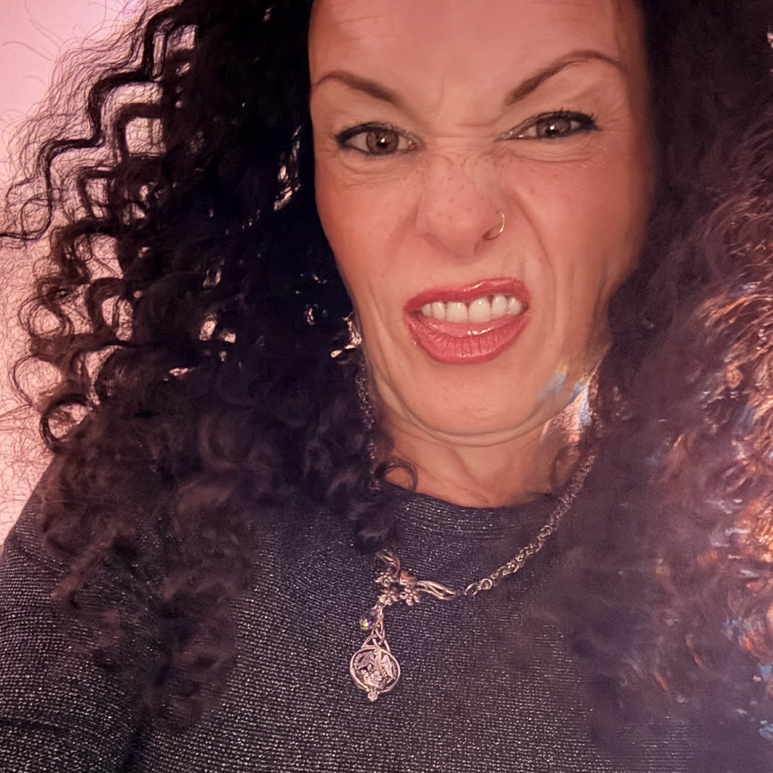 Expressive selfie wearing 22 inch deep wave lace front human hair wig showing voluminous curls and natural hair movement