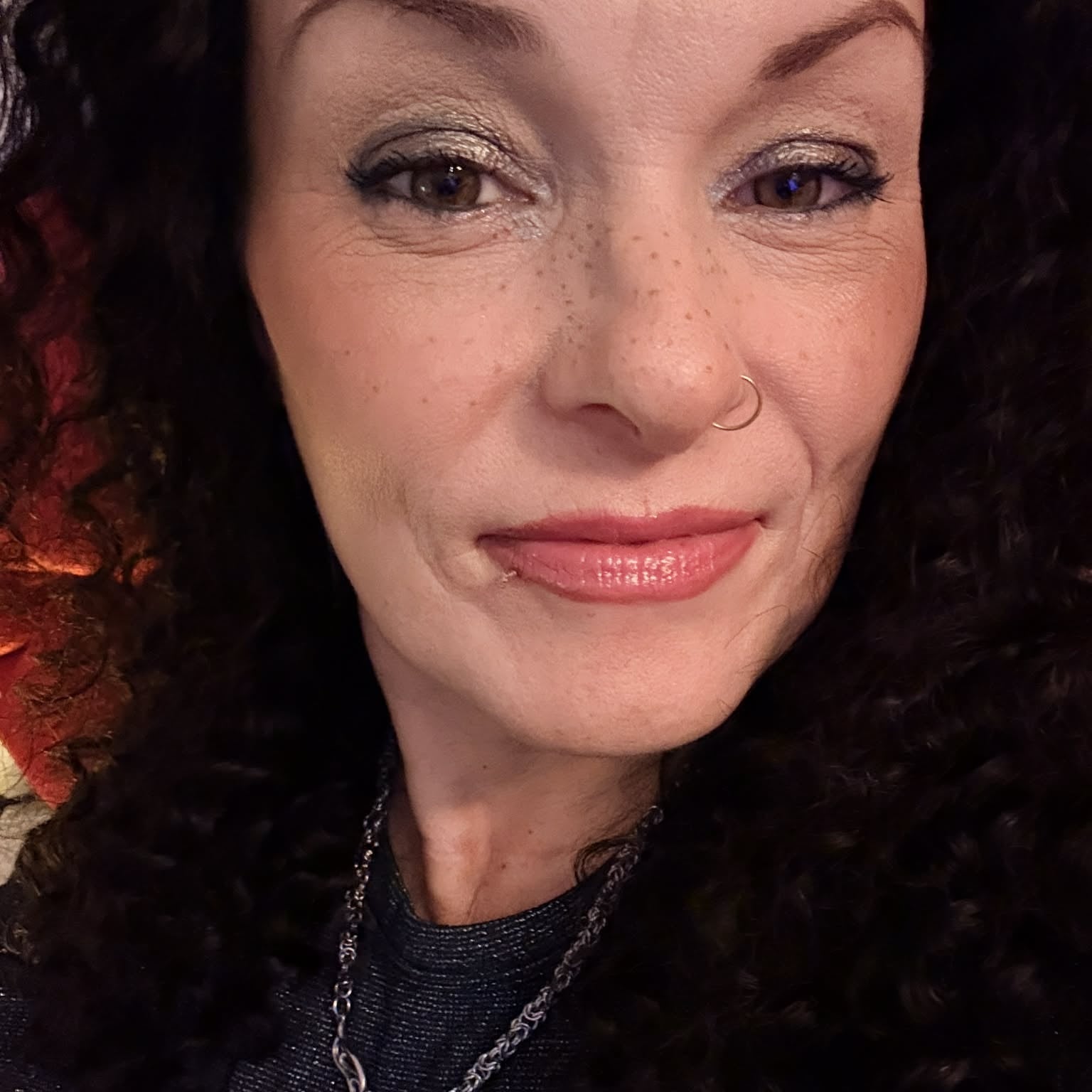 Close-up face selfie wearing 22 inch deep wave lace front human hair wig showing natural lace blend and defined spiral curls