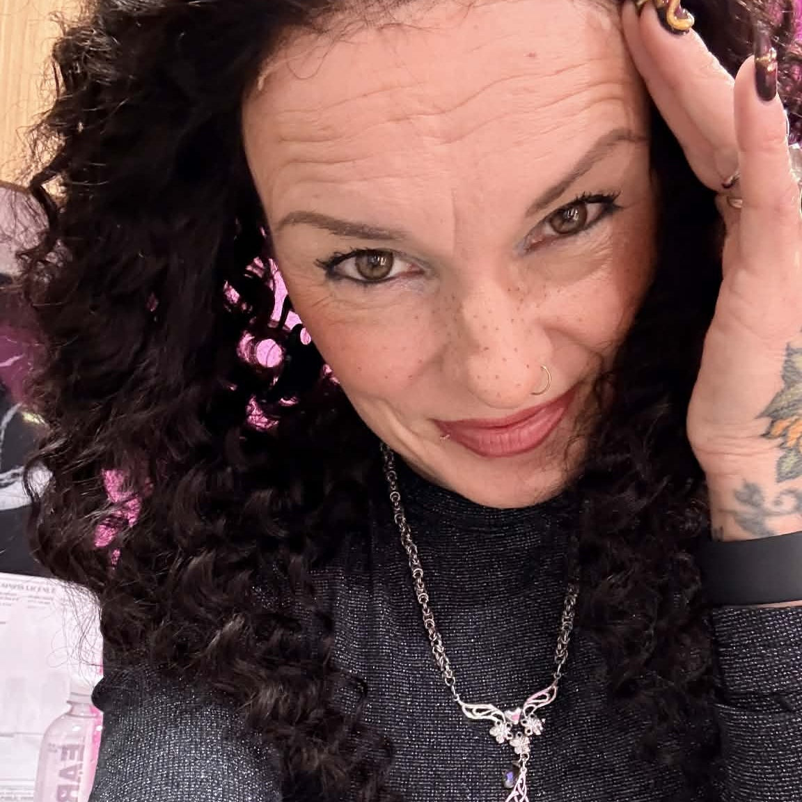 Selfie wearing 22 inch deep wave lace front human hair wig with hand touching hair showing curl bounce and natural movement