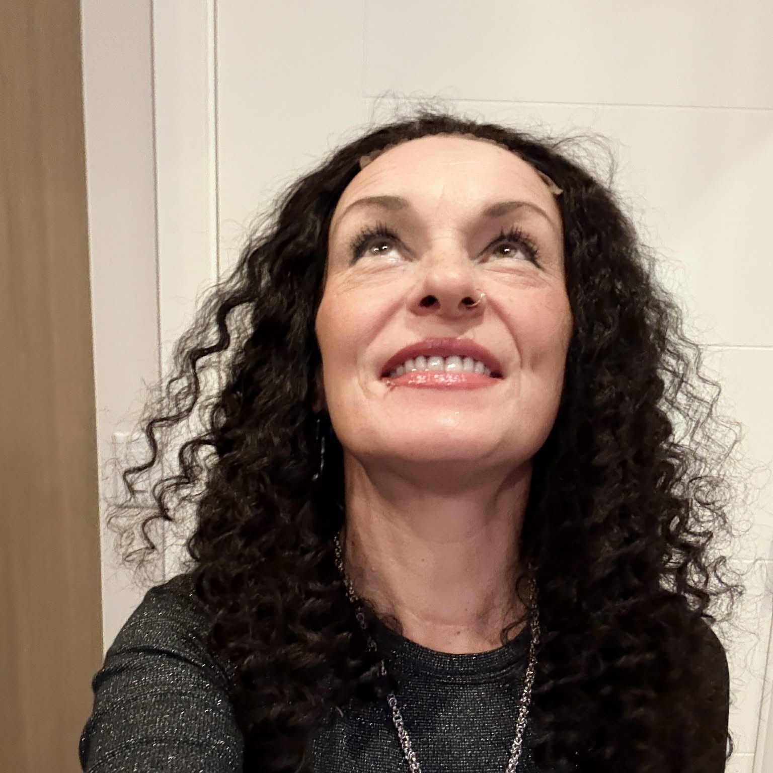 Selfie looking up wearing 22 inch deep wave lace front human hair wig showing full curl volume and natural hairline blend