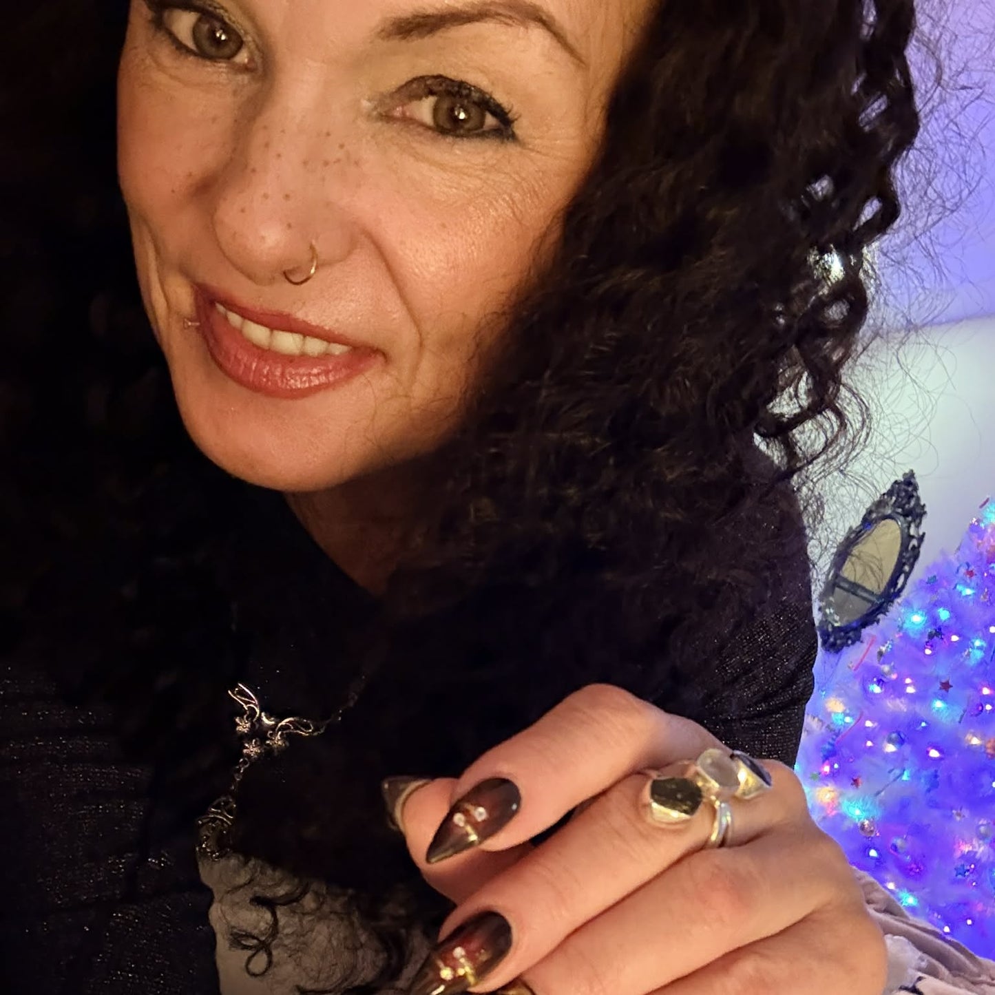 Selfie wearing 22 inch deep wave lace front human hair wig showing curls with decorative nails and cozy setting