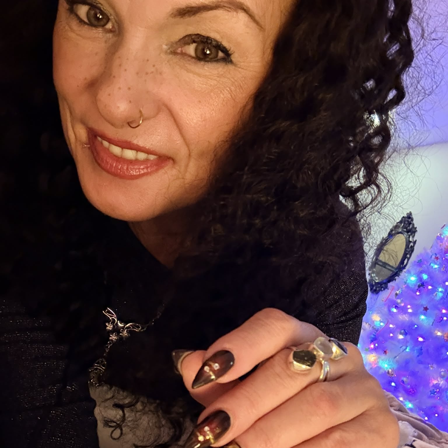 Selfie wearing 22 inch deep wave lace front human hair wig showing curls with decorative nails and cozy setting