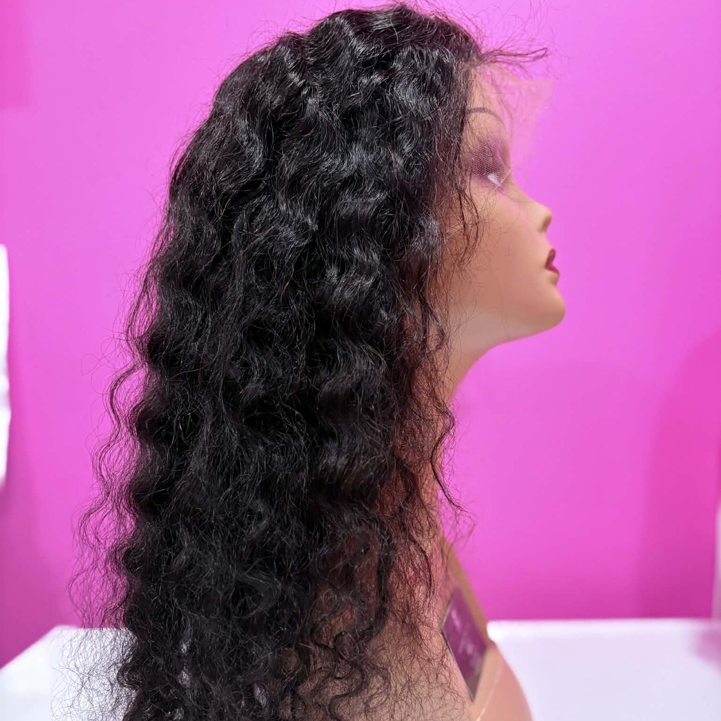 Right side profile of 22 inch deep wave 13x4 HD lace front human hair wig in natural black on mannequin showing wave definition and volume
