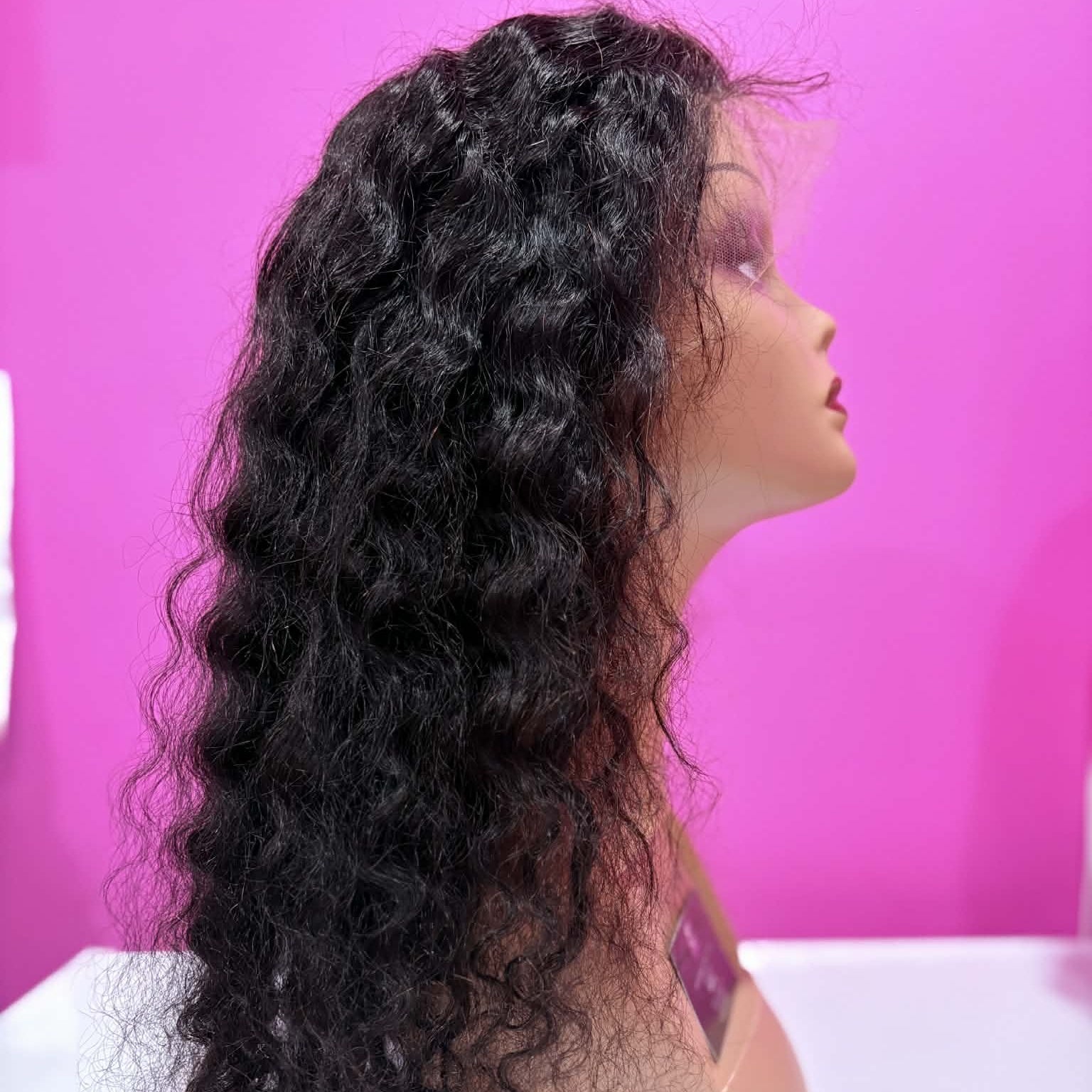 Right side profile of 22 inch deep wave 13x4 HD lace front human hair wig in natural black on mannequin showing wave definition and volume