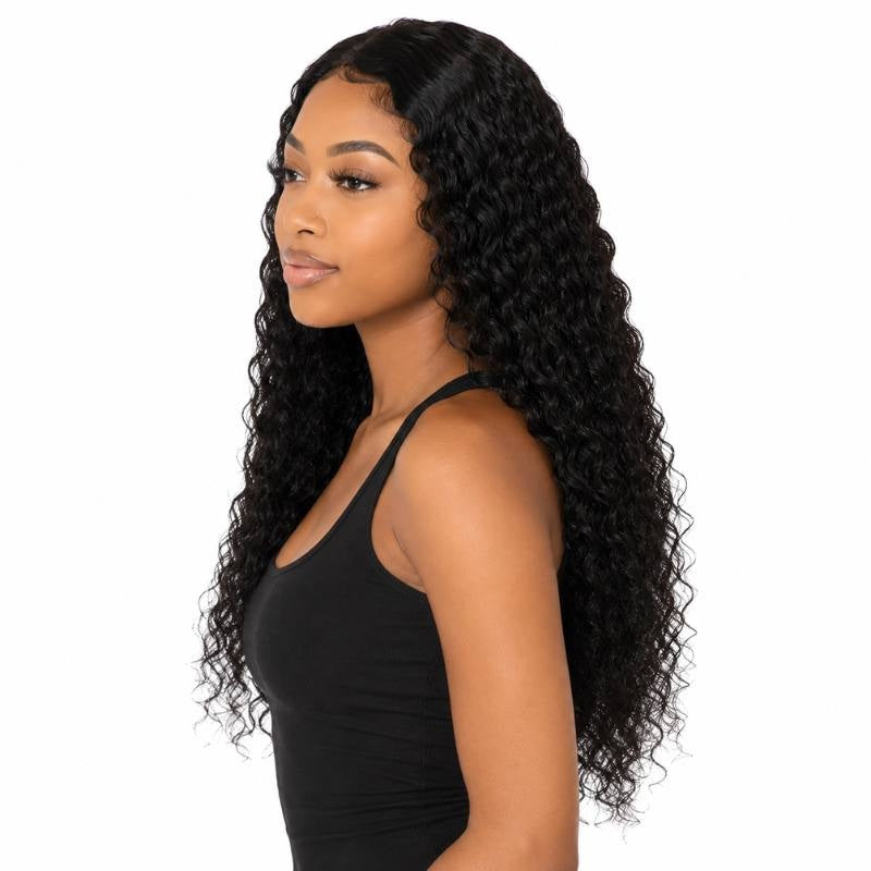 Model in side profile wearing a natural black deep wave human hair wig with curls running the full length of the back