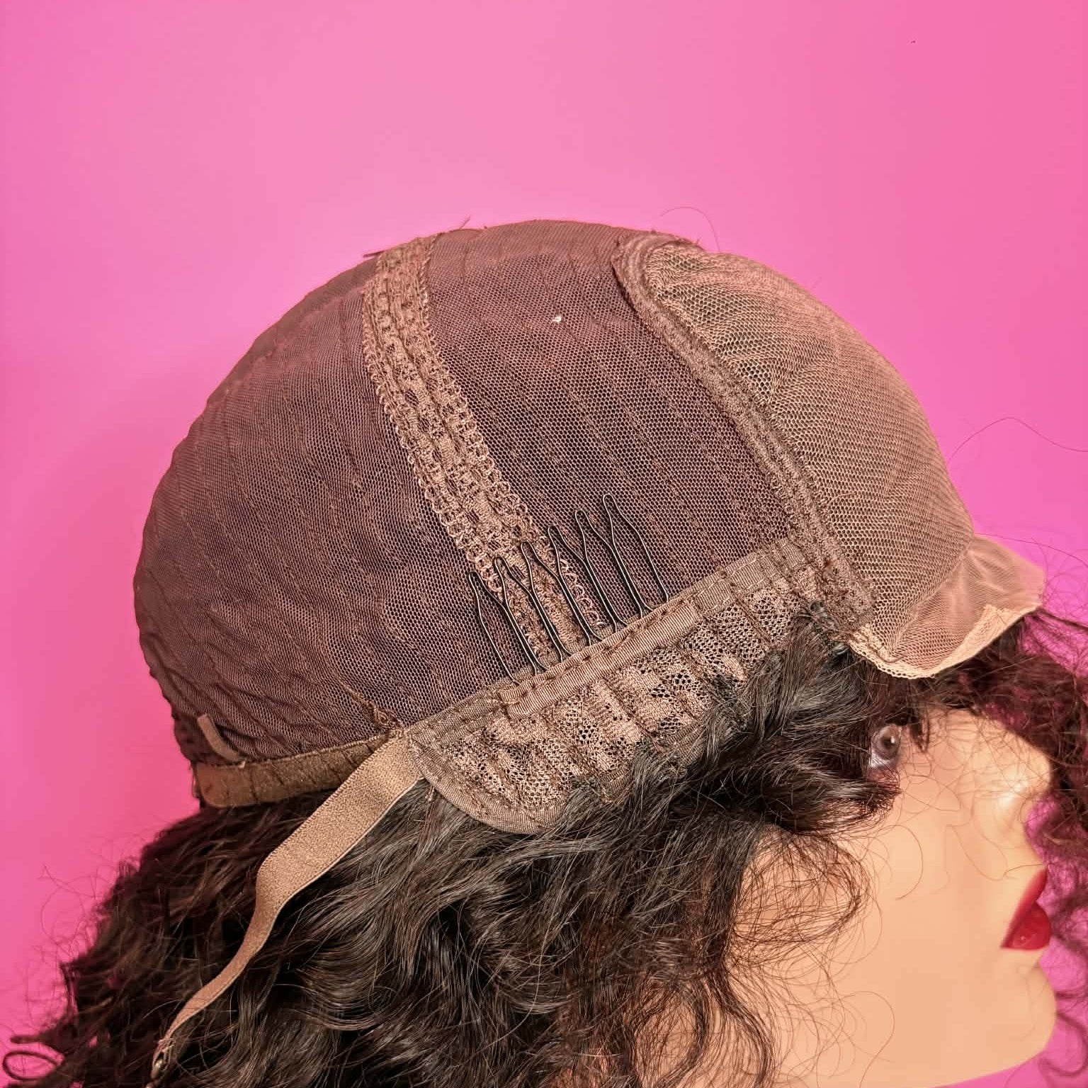 Interior back cap view of 16 inch deep wave closure human hair wig showing adjustable straps and weft construction