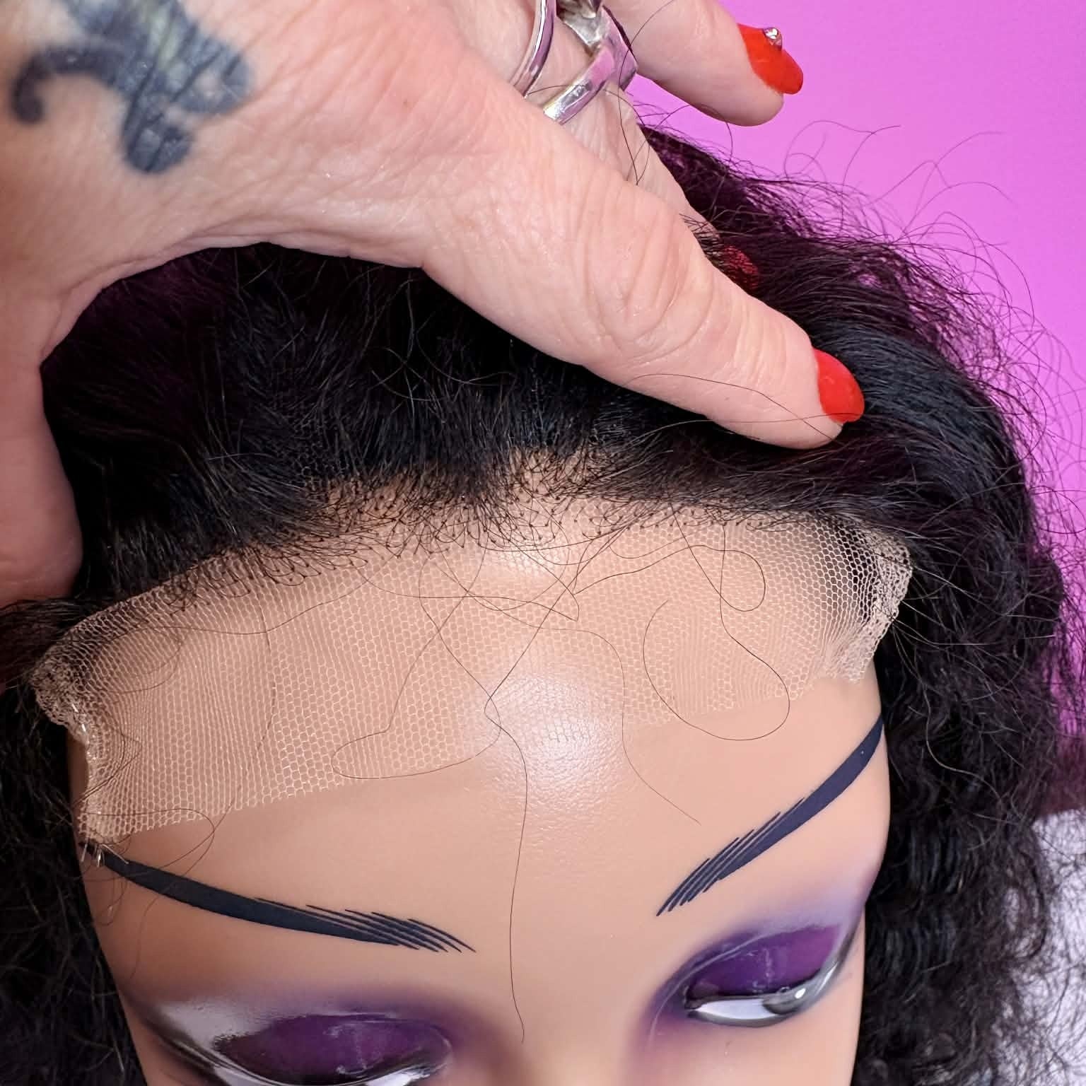 Close-up of transparent lace closure on 16 inch deep wave human hair wig showing lace mesh blend at hairline