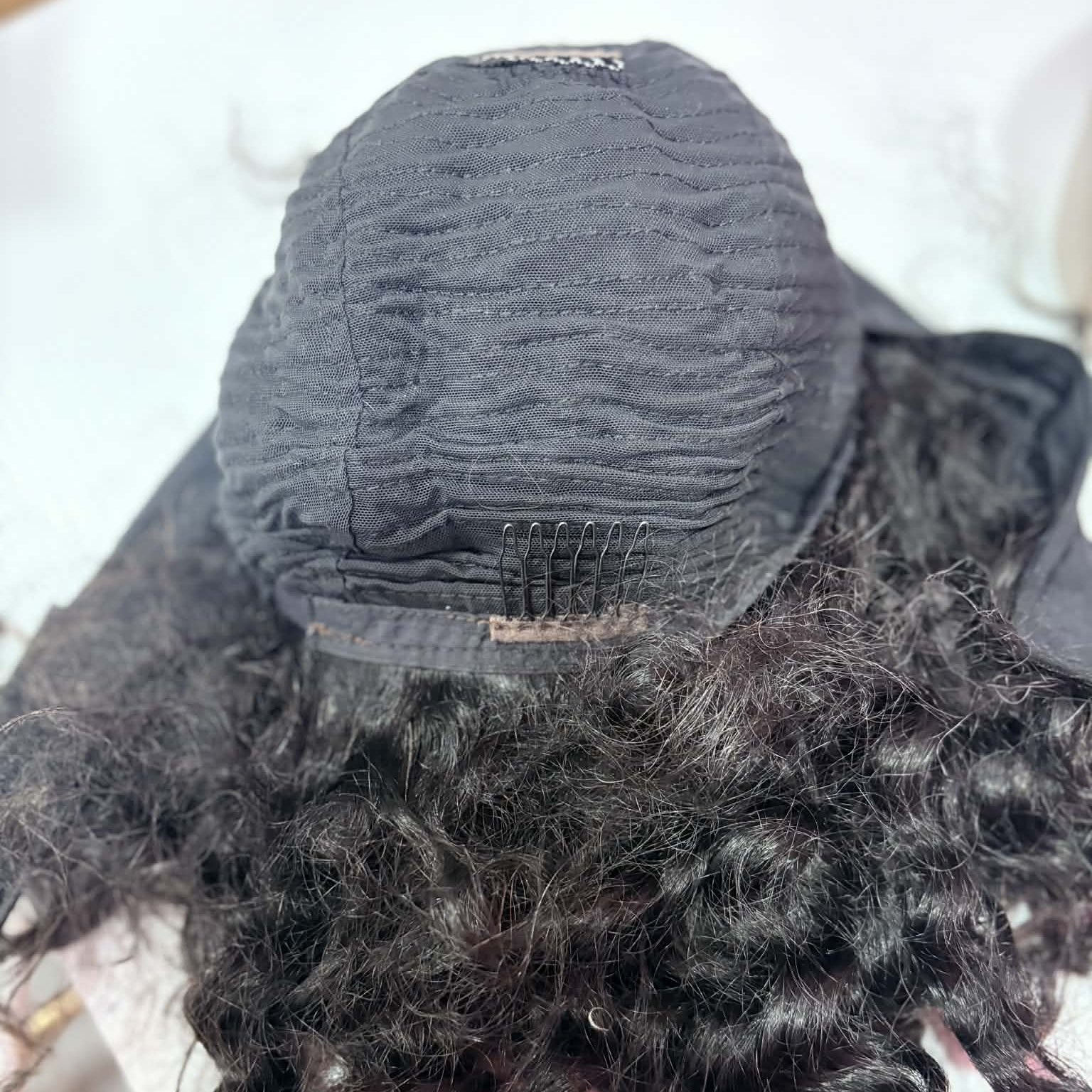 Interior front view of 14 inch deep wave headband human hair wig cap showing combs and machine-made weft rows