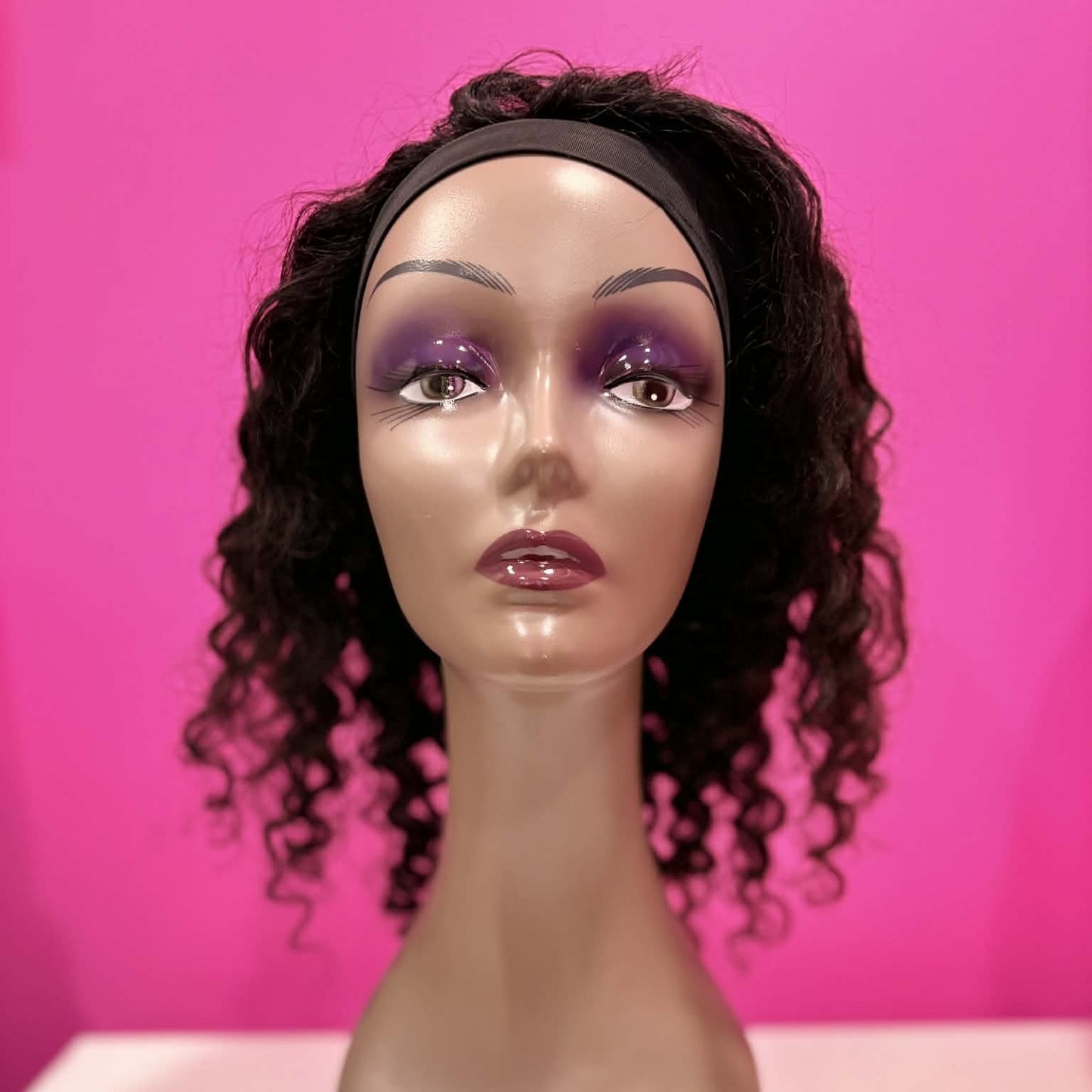 Front view of 14 inch deep wave headband human hair wig in natural black on mannequin showing headband attachment and face-framing curls