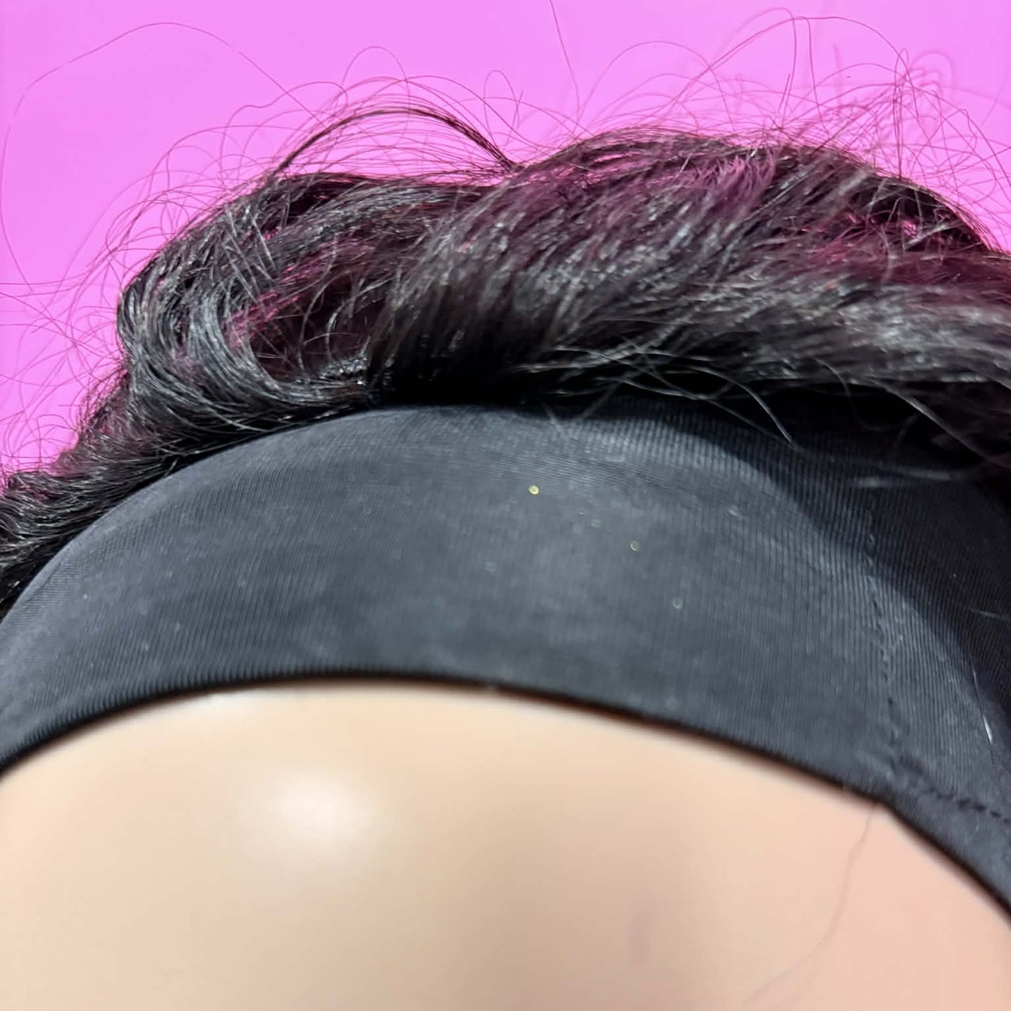 Close-up of black headband attachment on 14 inch deep wave headband human hair wig showing secure glueless fit on mannequin