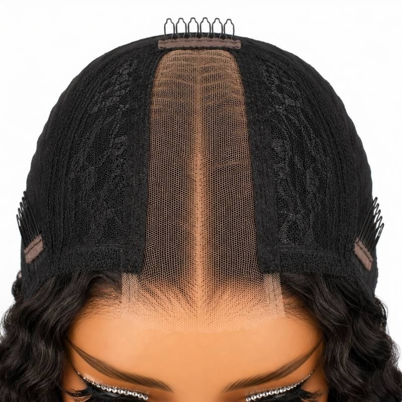Top down view of the cap on a natural black deep wave human hair wig showing the narrow lace closure strip running back from the hairline