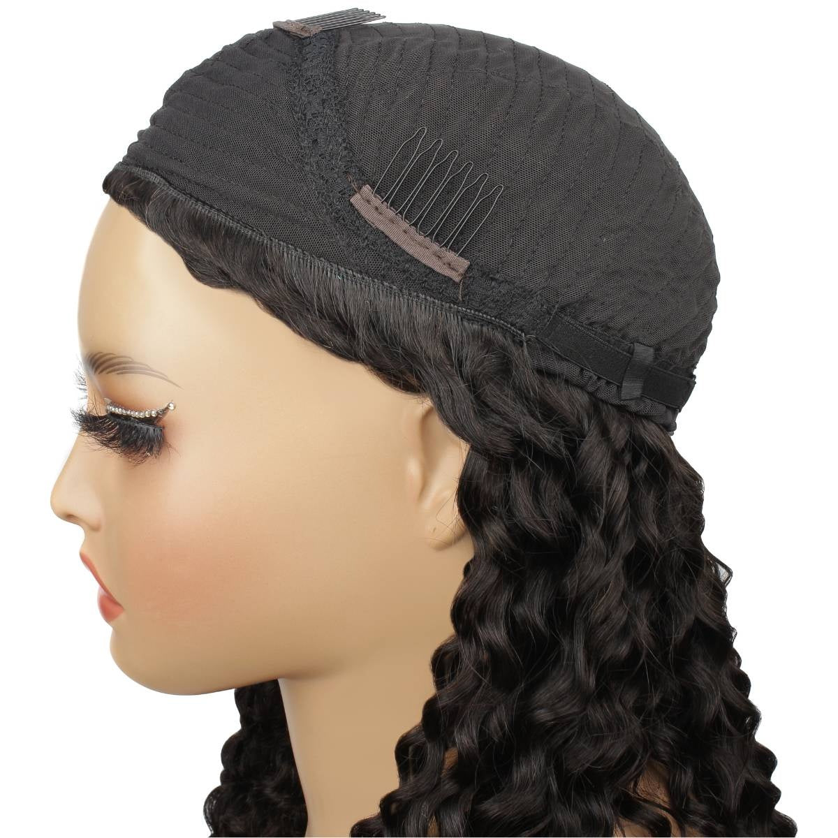 Side view of a natural black kinky curly human hair wig on a mannequin showing the cap set back from the hairline with combs and an elastic band