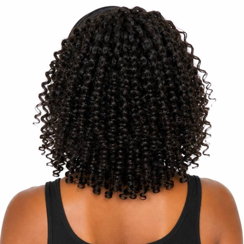 Back view of a model wearing a natural black kinky curly human hair wig with spiral coils ending just past the shoulders