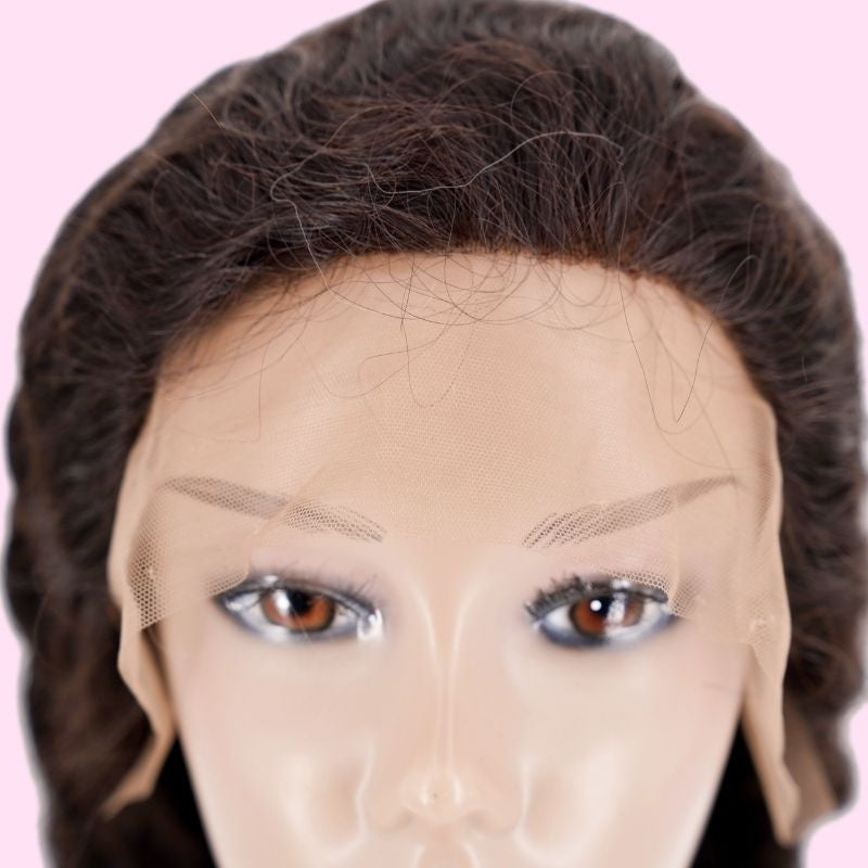 Close-up of the uncut lace front on a natural black loose wave human hair wig fitted to a mannequin head showing the hairline and baby hairs