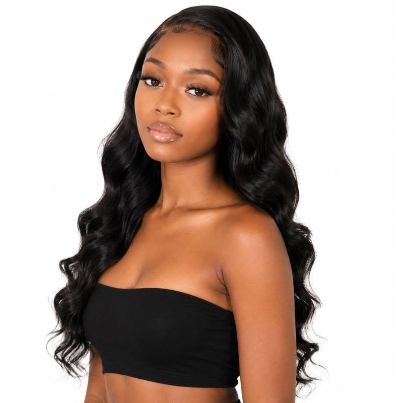 Model wearing a natural black loose wave lace front human hair wig with a middle part and waves falling past the chest
