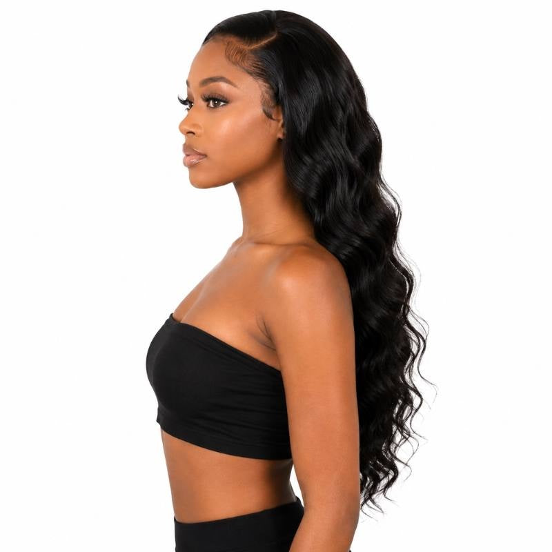 Profile view of a model wearing a natural black loose wave human hair wig with the hair pushed back and long waves running down the back