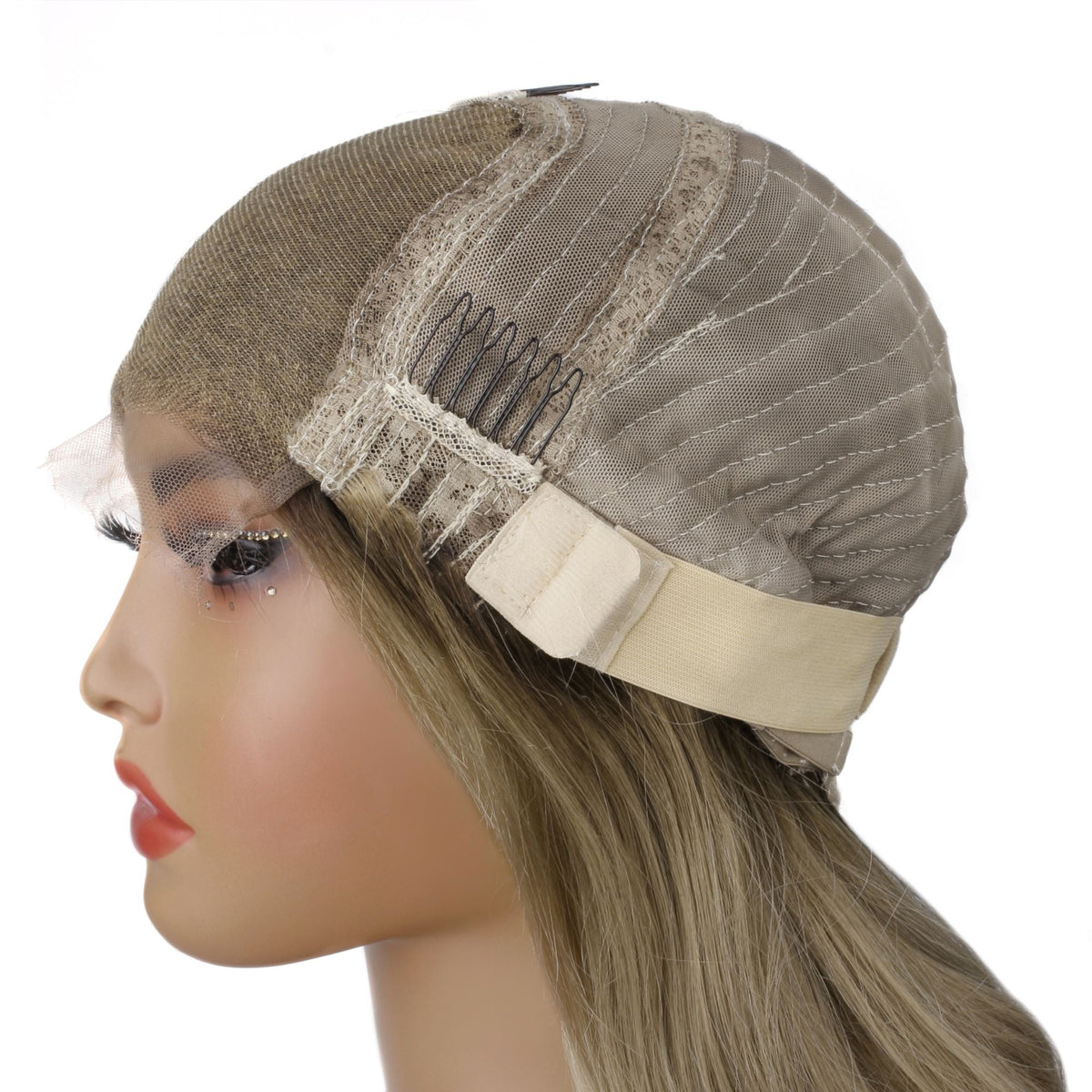 Cap construction of a blonde body wave human hair wig on a mannequin showing the closure panel, a comb, elastic band and stitched weft rows