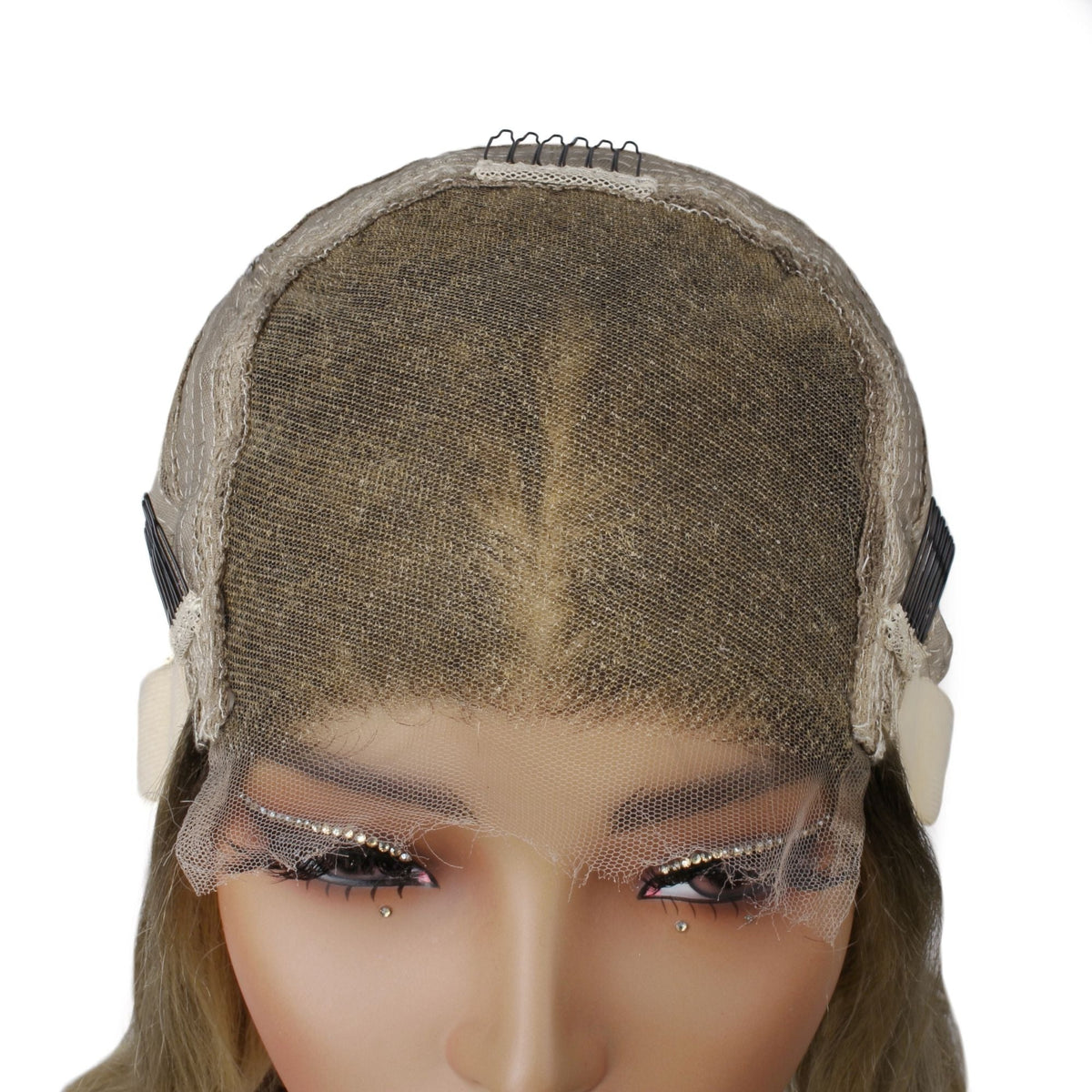 Front of a body wave human hair wig cap on a mannequin showing the closure panel across the crown and a comb at each temple