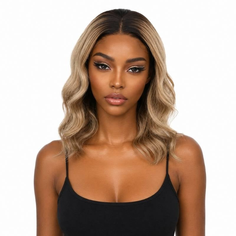 Model wearing a natural black to platinum blonde ombre body wave bob human hair wig with dark roots at the middle part and waves at the collarbone