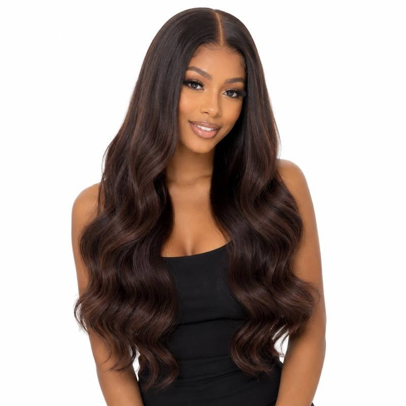 Model wearing a natural black to chocolate brown ombre body wave human hair wig with a middle part and long waves past the chest