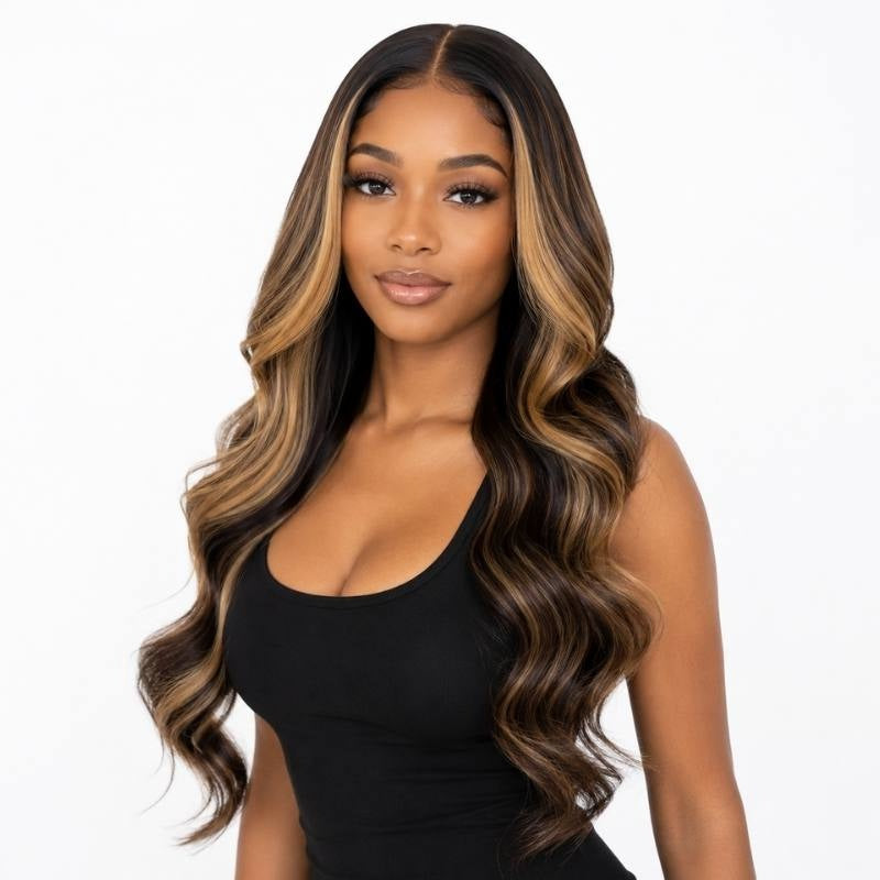 Model wearing a natural black body wave human hair wig with chocolate brown and honey blonde balayage in face framing pieces and through the waves
