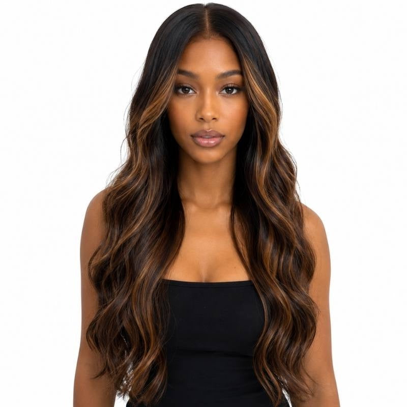 Model wearing a natural black body wave human hair wig with toffee balayage streaks through the mid lengths and a centre part