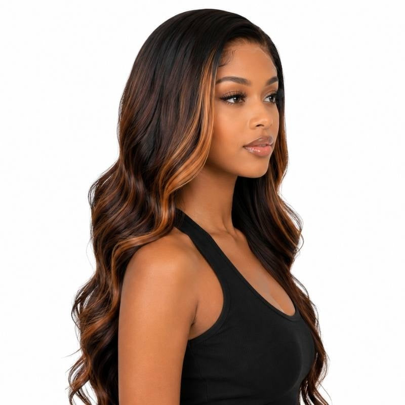 Model in a three quarter turn wearing a natural black body wave human hair wig with toffee and burgundy balayage running through the waves