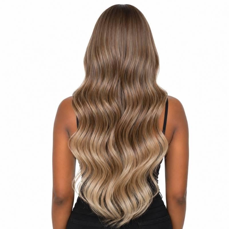 Back view of a brown to blonde ombre body wave human hair wig on a model showing dark roots grading into blonde ends