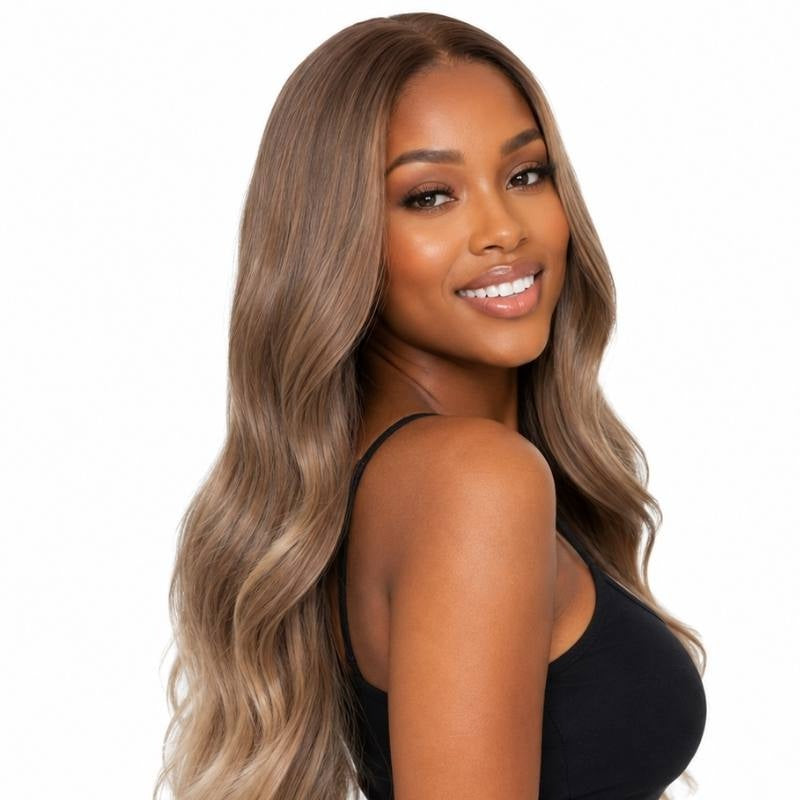 Model turned over the shoulder wearing a brown body wave human hair wig with blonde balayage lightening the mid lengths and ends