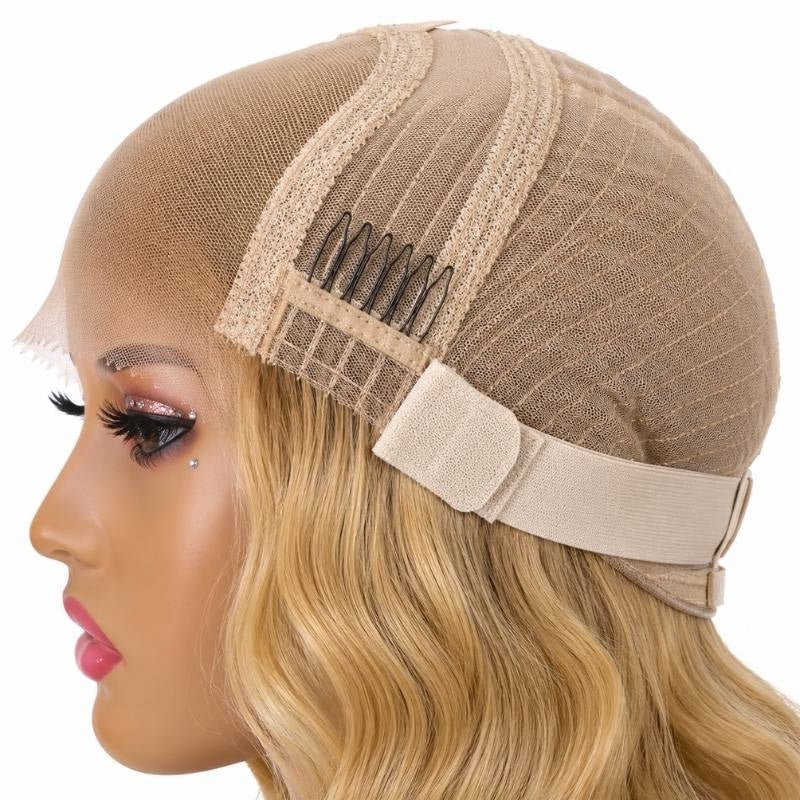 Side of a blonde body wave human hair wig cap on a mannequin showing a comb, the elastic band and blonde waves below