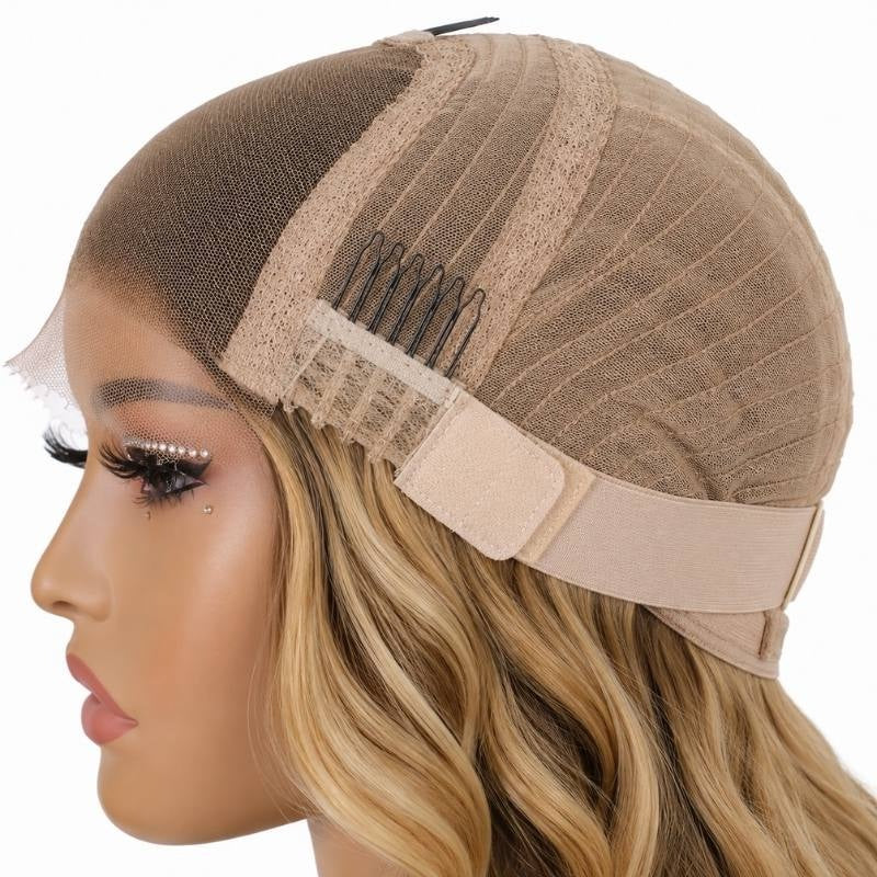Side of a body wave human hair wig cap on a mannequin showing a comb, the elastic band and honey blonde waves below
