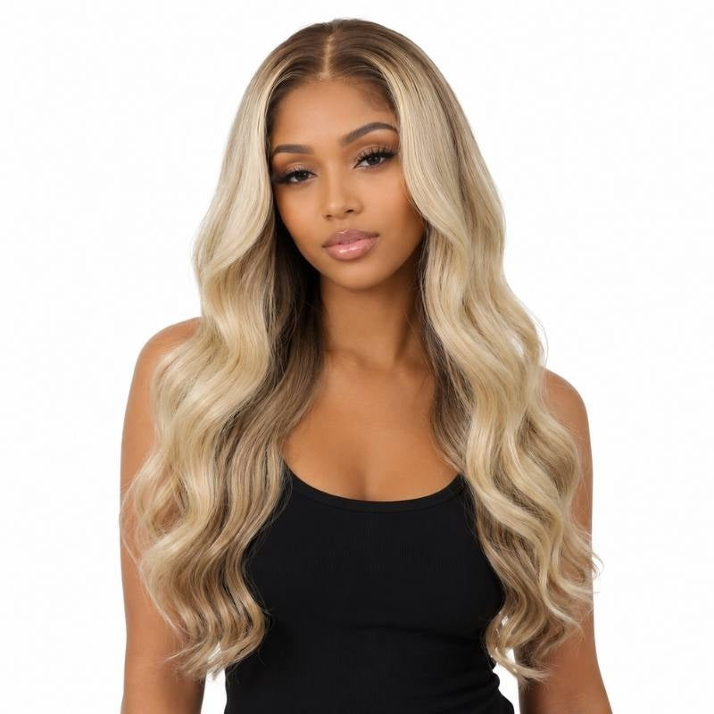 Model wearing a chocolate brown to platinum blonde ombre body wave human hair wig with a dark root melting into blonde waves