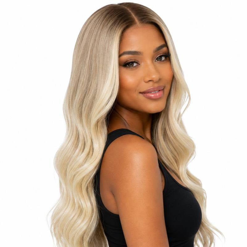 Honey blonde to platinum blonde body wave human hair wig on a model turned over the shoulder showing the waves and a middle part
