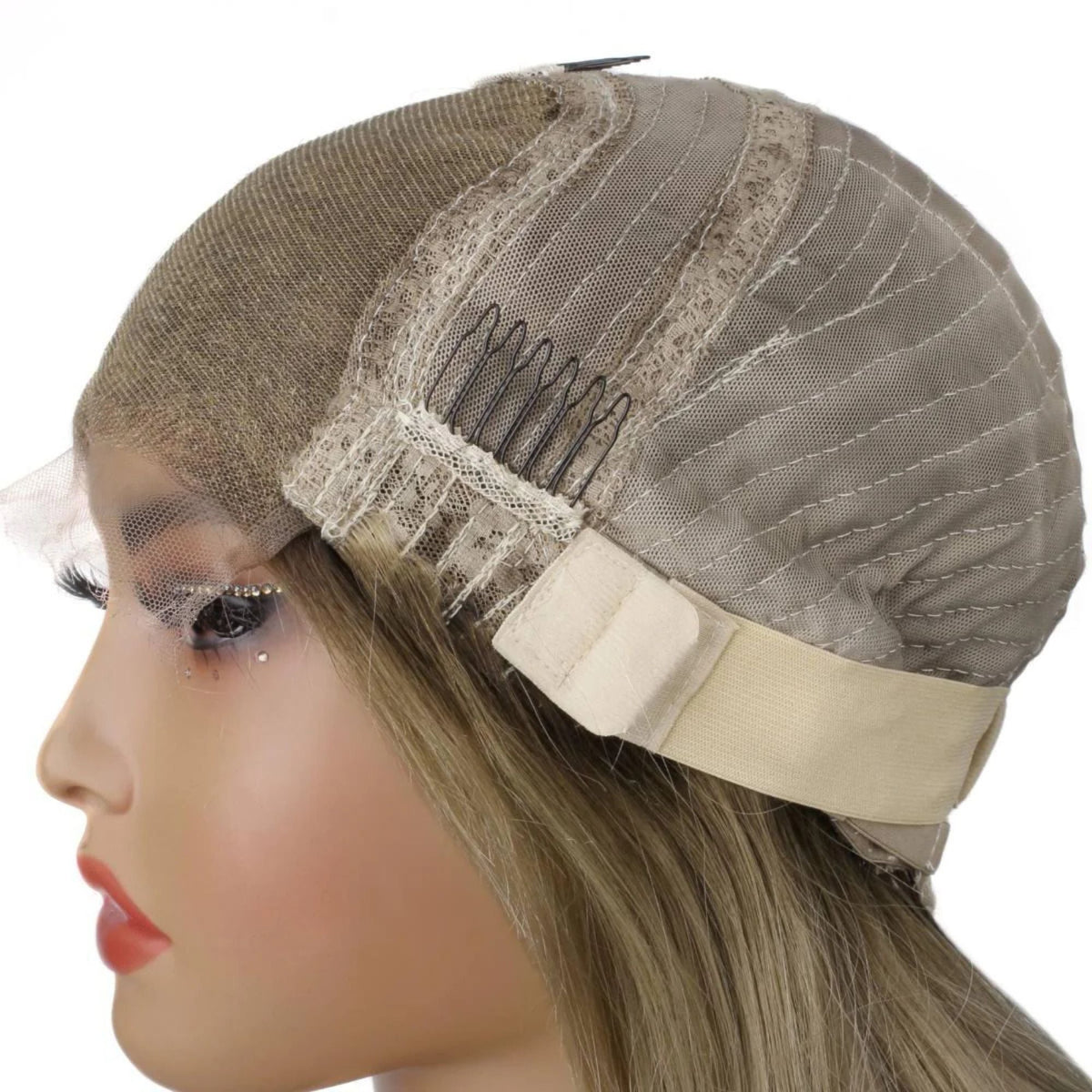 Cap of a honey blonde and platinum blonde body wave human hair wig folded back on a mannequin showing the lace panel, a comb and the adjustable strap